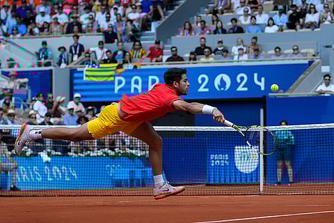 Carlos Alcaraz of Spain returns a shot during men's singles semifinals tennis match